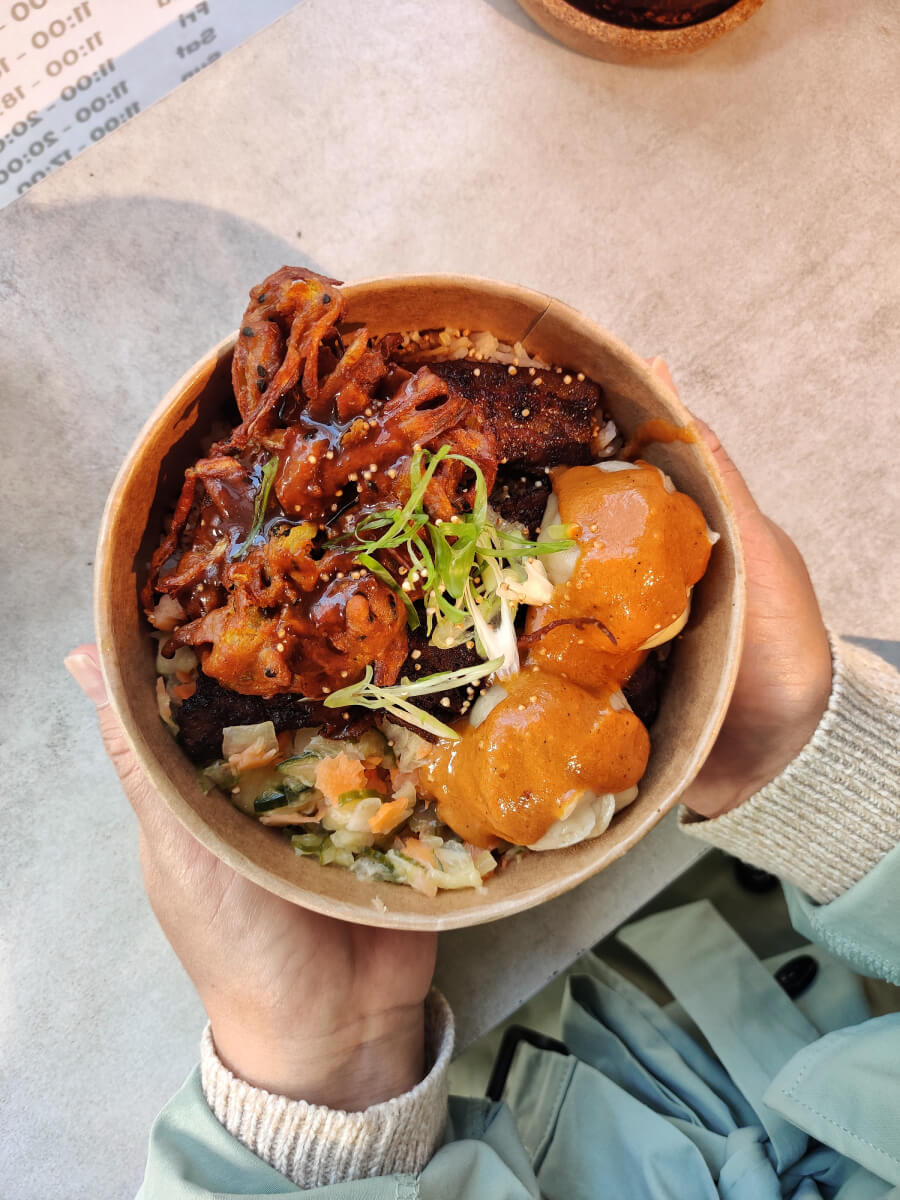 A close up top view of someone holding the Marse combo bowl