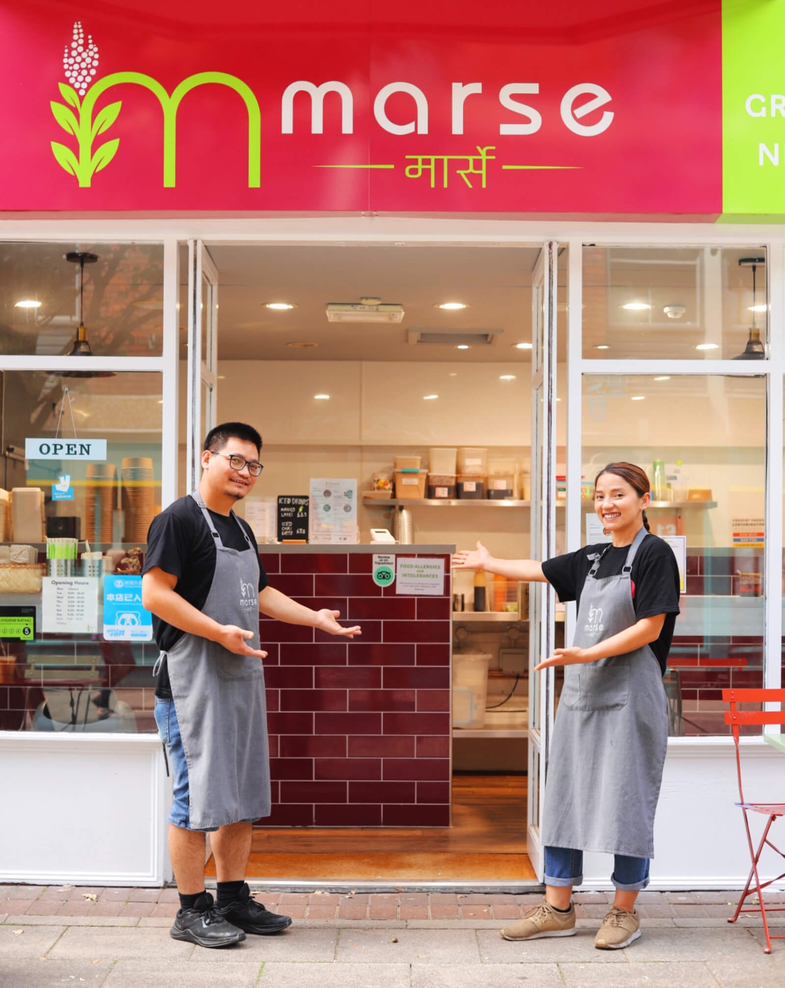 Laxmi and Santosh in front of Marse store